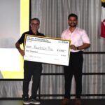 Manikanta Sirumalla is holding his prize check for $4,000 with Greg Cangialosi.