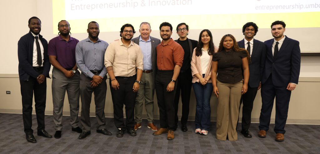Launchpad 26 Cohort, a group of students are standing acorss the stage smiling after presenting about their summer launchpad ventures